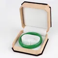 Green jade bangle displayed in a premium octagonal velvet box with beige fabric finish - Bracelet Box / Yellow With White Interior