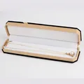 Elegant gold chain necklace with pearl pendant in long beige textured jewelry box - Necklace Box / Yellow With White Interior