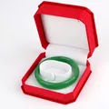 Octagonal red velvet jewelry box holding a fine green jadeite bracelet bangle - Bracelet Box / Red With White Interior