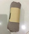 Rolled light brown cotton linen scarf secured with a paper band on a tile floor - Mid-Length / 160*50CM / Khaki