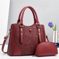 Burgundy geometric embossed tote bag and pouch set with golden hardware in soft studio light - Red