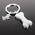 Silver metal keychain featuring cute dog and bone charms on a dark reflective surface - Silver Dog Bone Puppy Style