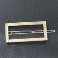 Minimalist golden rectangular metal hair clip with a sleek polished finish on black leather - Rectangle / Gold