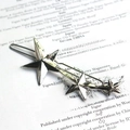 Silver star-shaped metal hair clip featuring a minimalist three-star shooting star design - Star / Silver