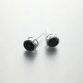 Macro detail of 925 sterling silver stud earrings with black round-cut zircon stones - 6mm / Rhodium Plated Black Zirconia