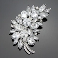 Elegant silver leaf brooch with clear marquise cut crystal stones on reflective surface - Silver White