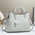Light gray faux leather handbag with woven handles and a metallic bear charm pendant - 26x12x20cm / Gray
