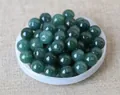 Close-up of polished dark green natural jade beads with center holes for DIY jewelry - 8mm / Dark Teal