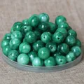 Close-up of green natural jade round beads for DIY jewelry and traditional clothing - 8mm / Emerald Green