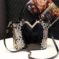 Fashionable black patent leather handbag with floral sequins and V-shaped metal trim - Black