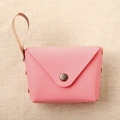 Detailed macro view of a pink envelope style mini coin purse with gold button and hand strap - Rose Red