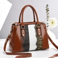 Brown patent leather tote bag with white crocodile and snake skin patterns and gold studs - Earthy Yellow