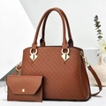 Detail view of brown quilted leather tote with matching clutch and golden ring hardware - Brown