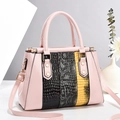 Elegant pink handbag with crocodile texture panels and adjustable crossbody strap - Pink