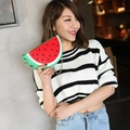 Watermelon slice crossbody bag with gold chain strap worn by a female model - Watermelon red