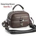Detail view of large dark taupe shoulder bag featuring triple zippers and woven strap - Dark Gray-brown