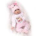 Realistic 40cm baby doll with blue eyes and pink bear outfit on white fur mat - Pink Bear Style / 55 cm