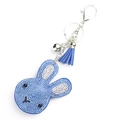 Detail shot of a blue rhinestone bunny keychain with a matching leather tassel and silver clip - Sapphire Blue