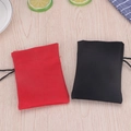 Red and black drawstring pouches on a wooden table with lemon decor and plaid cloth - Black Bag