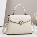 Close-up of cream textured leather crossbody bag with elegant golden metallic buckle - Off-white