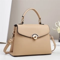 Detailed close-up of apricot lychee pattern leather handbag with golden semicircular lock - Apricot