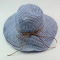 Wide brim raffia sun hat in light blue with a dark brown bow accent for summer beach trips - Lake Blue