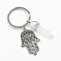 Détail de la main de Hamsa et du prisme en opale sur un porte-clés en argent vieilli - Opale