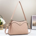 Detail showing clover embossed faux leather and pale gold hardware on pink crossbody bag - Pink