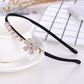 Detail of black headband with gold clover motif inlaid with pearls and rhinestones - Pearl Four-leaf Clover