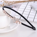 Detail of black fabric headband with golden heart rhinestone and pearl on a tea cup - Pearl Heart