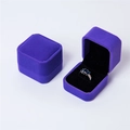 Elegant purple velvet jewelry box featuring a matching ring with blue gemstones - Purple