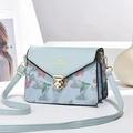 Light blue floral embroidered crossbody bag with golden flower clasp and adjustable strap - Blue