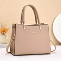 Detail shot of the lychee grain leather texture and golden logo on the beige handbag - Khaki