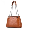 Caramel brown quilted chain shoulder bag with embossed floral texture and clover charm - Earthy Yellow