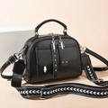 Black faux leather handbag with silver rivets and geometric woven shoulder strap - Black