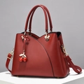 Elegant dark red crossbody handbag with gold Mickey-shaped hardware and cherry charm - Wine Red