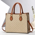 Macro shot of Oumifei beige canvas tote bag with brown leather trim in minimalist studio setting - Apricot With Yellow