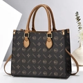Close-up of brown tote bag featuring textured faux leather and golden star pattern print - Coffee & Bronze