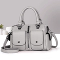 Gray Boston handbag with pebble leather texture and crossbody strap in a modern setting - Gray