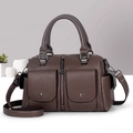 Detail view of brown pebbled Boston bag with magnetic pockets and dark hardware - Coffee