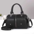 Detail of black pebbled leather handbag featuring textured finish and gunmetal hardware - Black