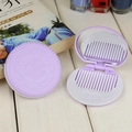 Purple cookie-shaped folding hairbrush with mirror featuring embossed heart pattern - Lavender