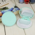 Portable mint green cookie-shaped folding hair comb and mirror set for travel - Light Lake Blue