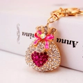 Sparkling crystal fortune bag keychain with pink enamel bow on golden alloy ring - Fuschia