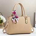 Detail of beige litchi grain handbag with gold hardware and floral scarf handle wrap - Khaki