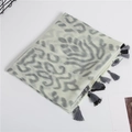 Detailed view of lightweight cotton-linen scarf featuring grey leopard print and tassels - Gray