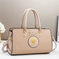 Close-up of beige faux crocodile texture and gold heart hardware on an elegant handbag - Khaki