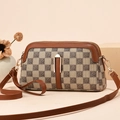 Classic checkered crossbody bag with brown leather trim on a warm minimalist background - Khaki/Checkerboard