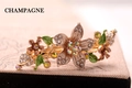 Champagne floral hair clip with crystal rhinestones and green enamel leaf accents - Champagne