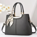 Dark grey lychee textured handbag with gold hardware and decorative scarf accent - Gray